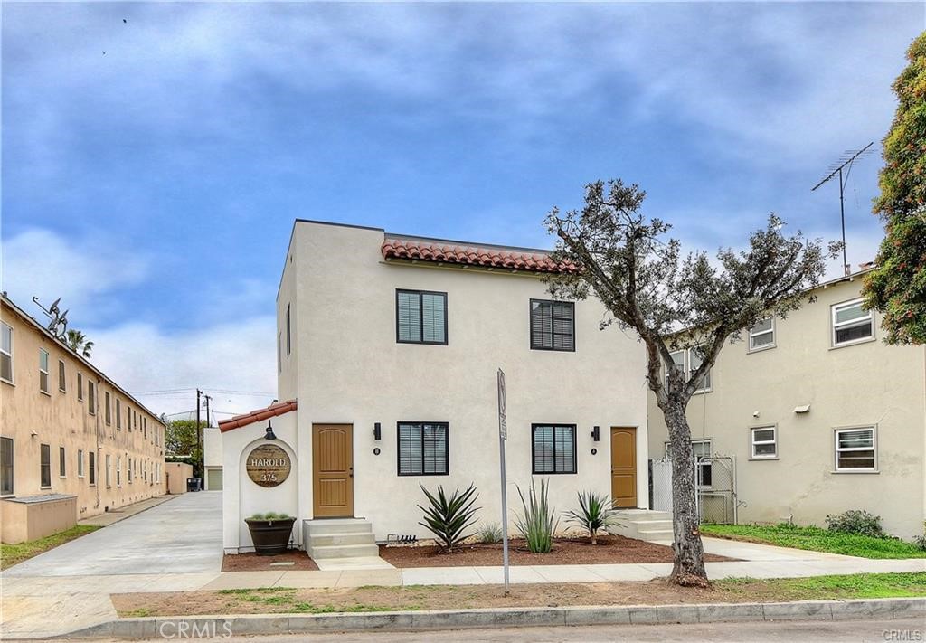 375 Termino Avenue, Unit A Long Beach, CA 90814 - Photo 1 of 13 a front view of a house with garden