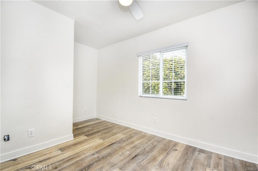 375 Termino Avenue, Unit A Long Beach, CA 90814 - Photo 7 of 13 an empty room with wooden floor and windows