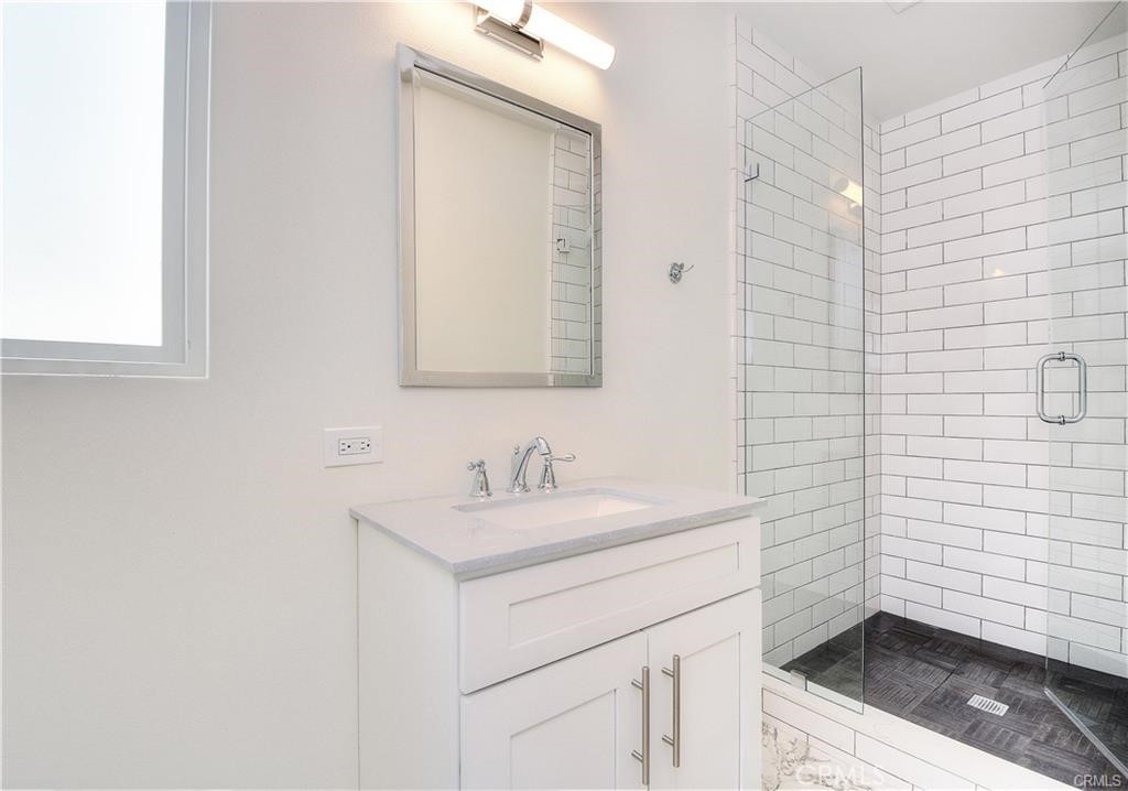 375 Termino Avenue, Unit A Long Beach, CA 90814 - Photo 8 of 13 a bathroom with a sink a toilet and mirror