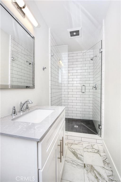 375 Termino Avenue, Unit A Long Beach, CA 90814 - Photo 9 of 13 a bathroom with a sink a toilet a mirror and shower