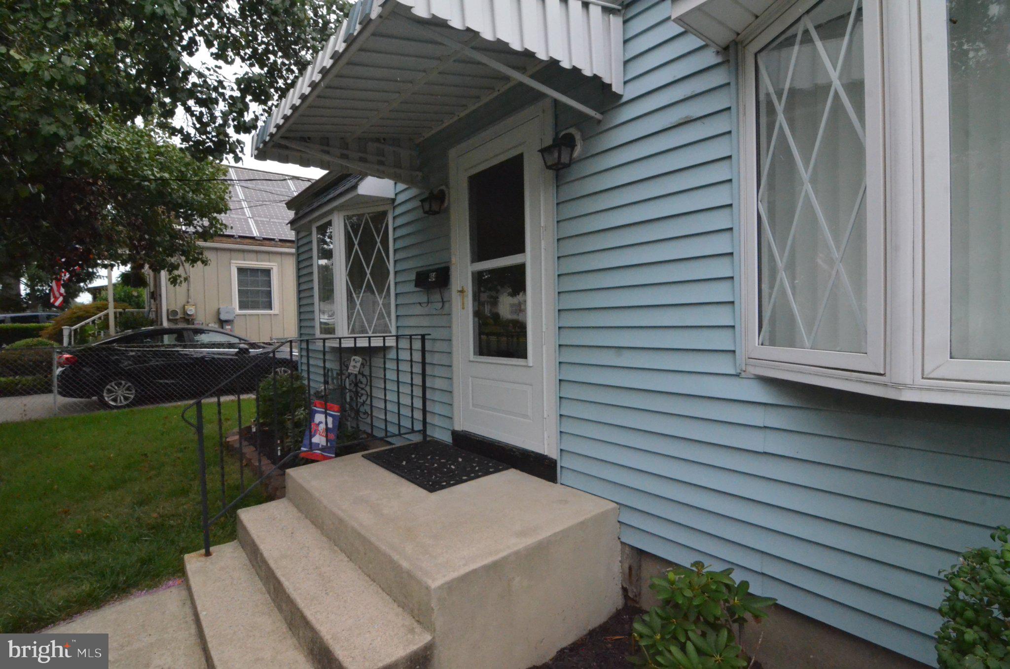 Charming blue facade with inviting steps.