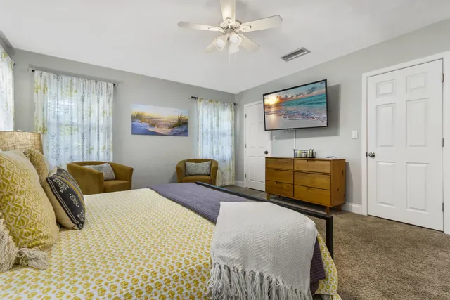 a view of a bathroom with granite countertop a sink and a window