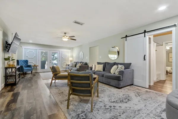 a living room with furniture and a chandelier