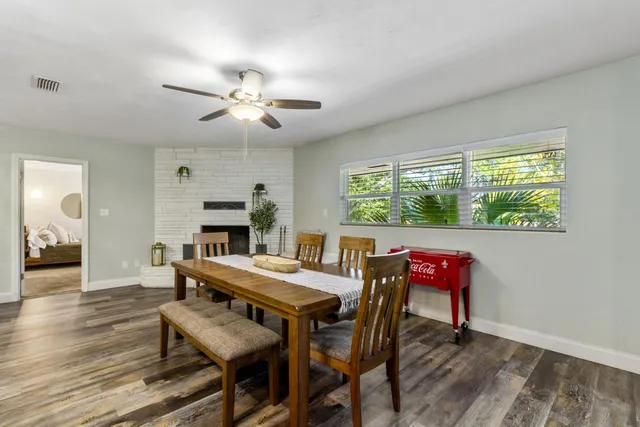 a view of a dining room with furniture and wooden floor
