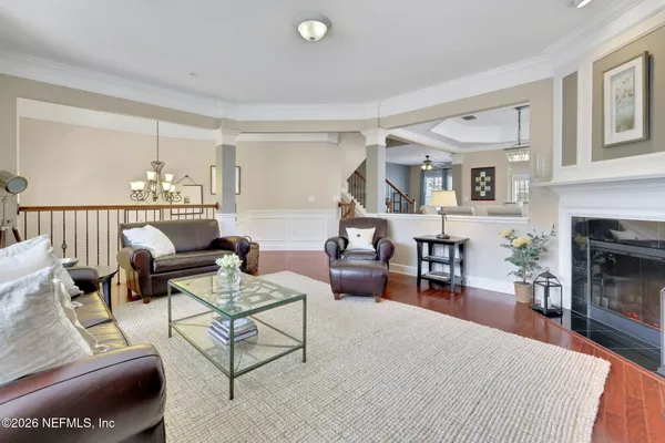 a view of a dining room with furniture and a chandelier