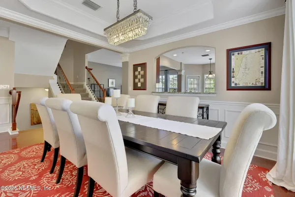 a kitchen with stainless steel appliances granite countertop wooden floor sink stove and refrigerator