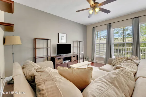 a spacious bedroom with a bed and a chandelier