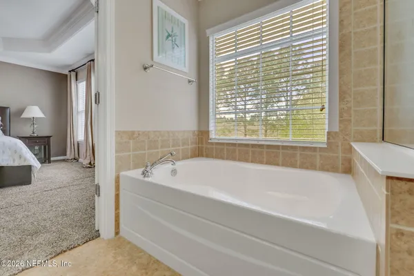 a bath tub sitting next to a white toilet