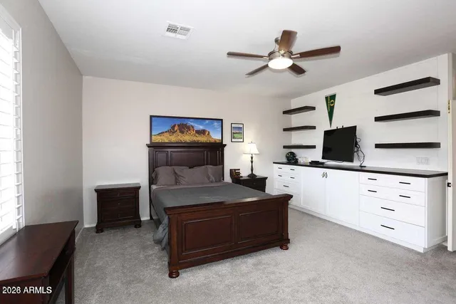 a living room with furniture and a ceiling fan