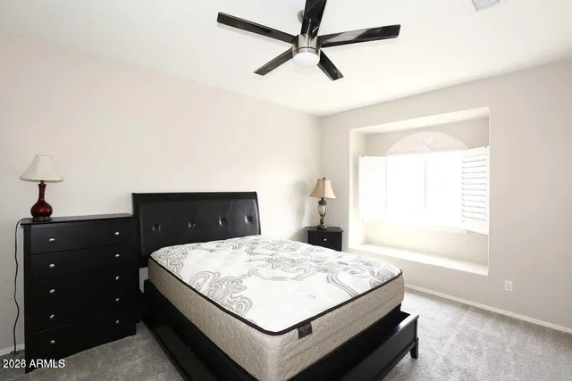 a bedroom with a bed and a dresser