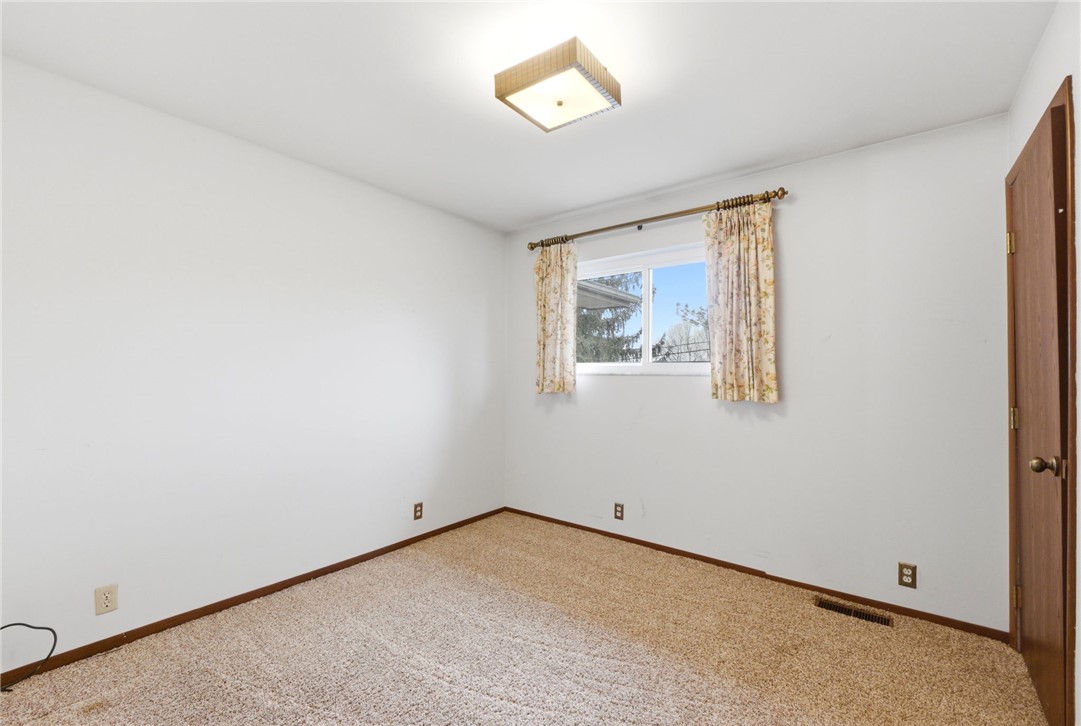 6711 Hamilton-Middletown Road Franklin, OH 45005 - Photo 21 of 49 This spacious bedroom offers ample natural light through a large window, creating a bright and inviting atmosphere.