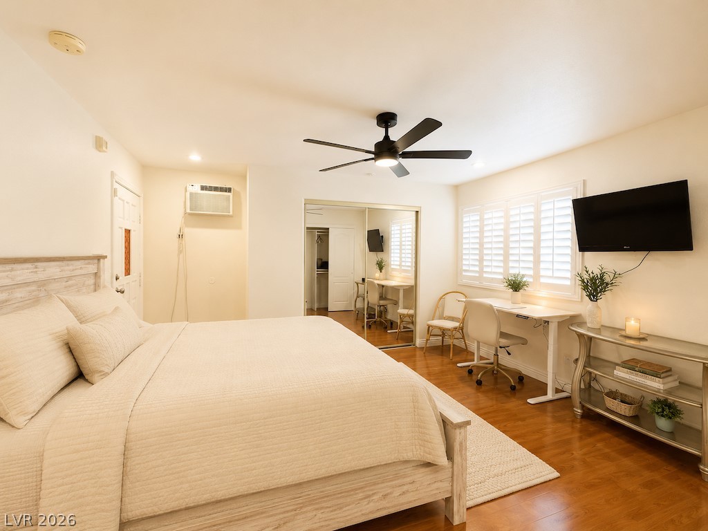 3010 East Viking Road Las Vegas, NV 89121 - Photo 30 of 48 Hardwood floors and bright window shutters illuminate this inviting primary bedroom.