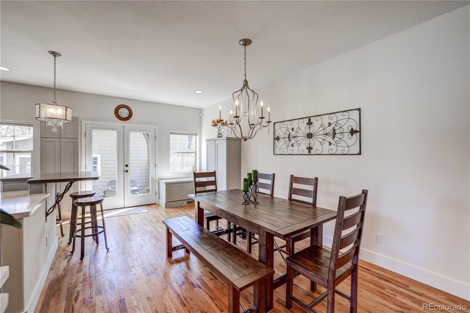 4530 Quitman Street Denver, CO 80212 - Photo 11 of 40 a view of a dining room with furniture window and wooden floor
