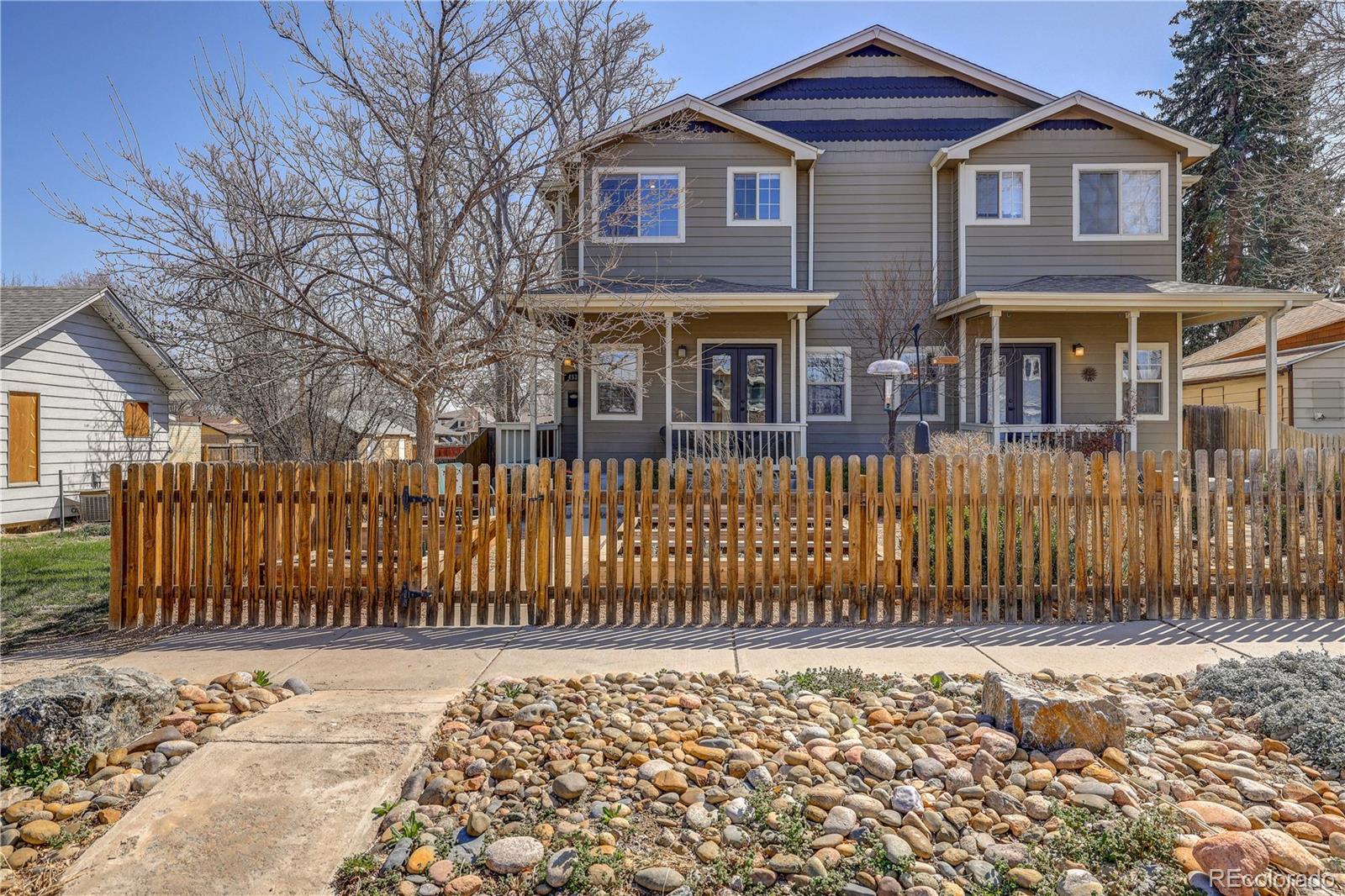 4530 Quitman Street Denver, CO 80212 - Photo 2 of 40 a front view of a house with a wooden fence