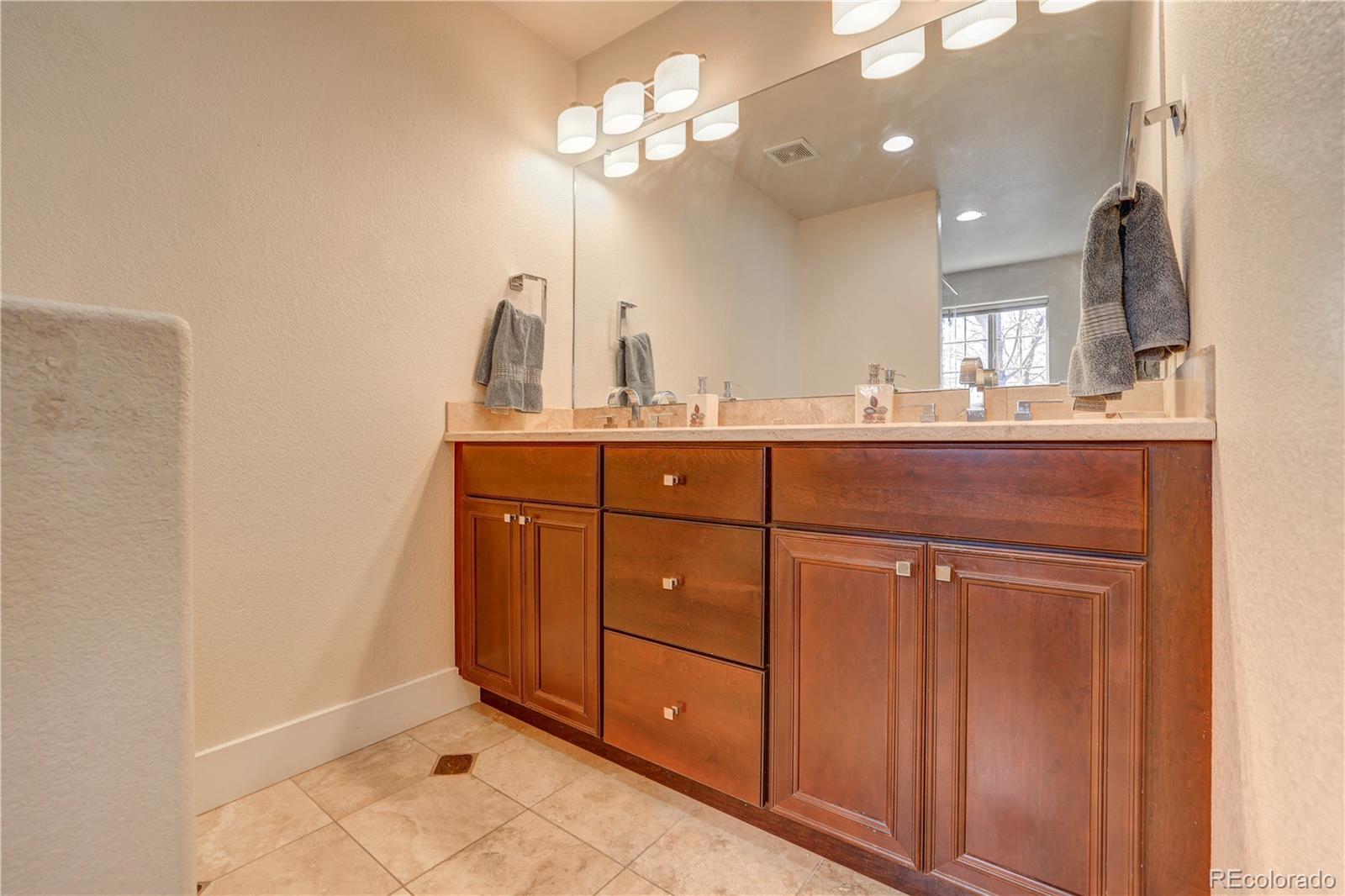 4530 Quitman Street Denver, CO 80212 - Photo 22 of 40 a bathroom with a sink a light fixture and a mirror