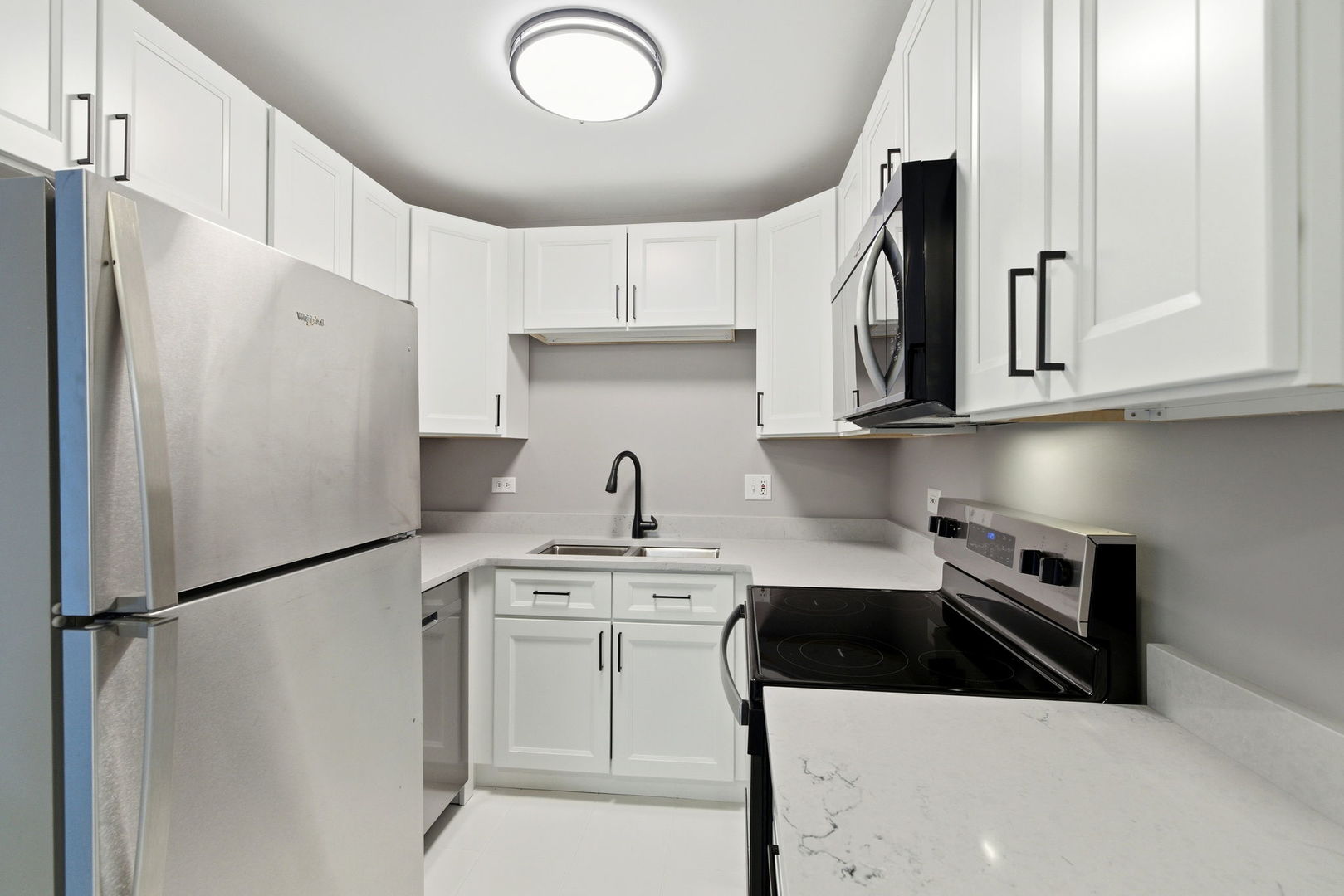 2800 Light Road, Unit 102 Oswego, IL 60543 - Photo 2 of 12 a kitchen with stainless steel appliances a refrigerator sink and cabinets