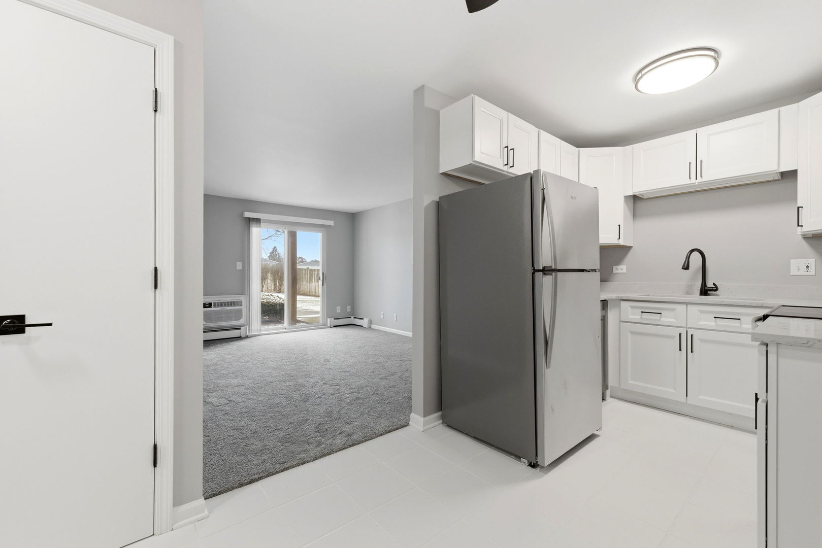 2800 Light Road, Unit 102 Oswego, IL 60543 - Photo 3 of 12 a kitchen with refrigerator and cabinets