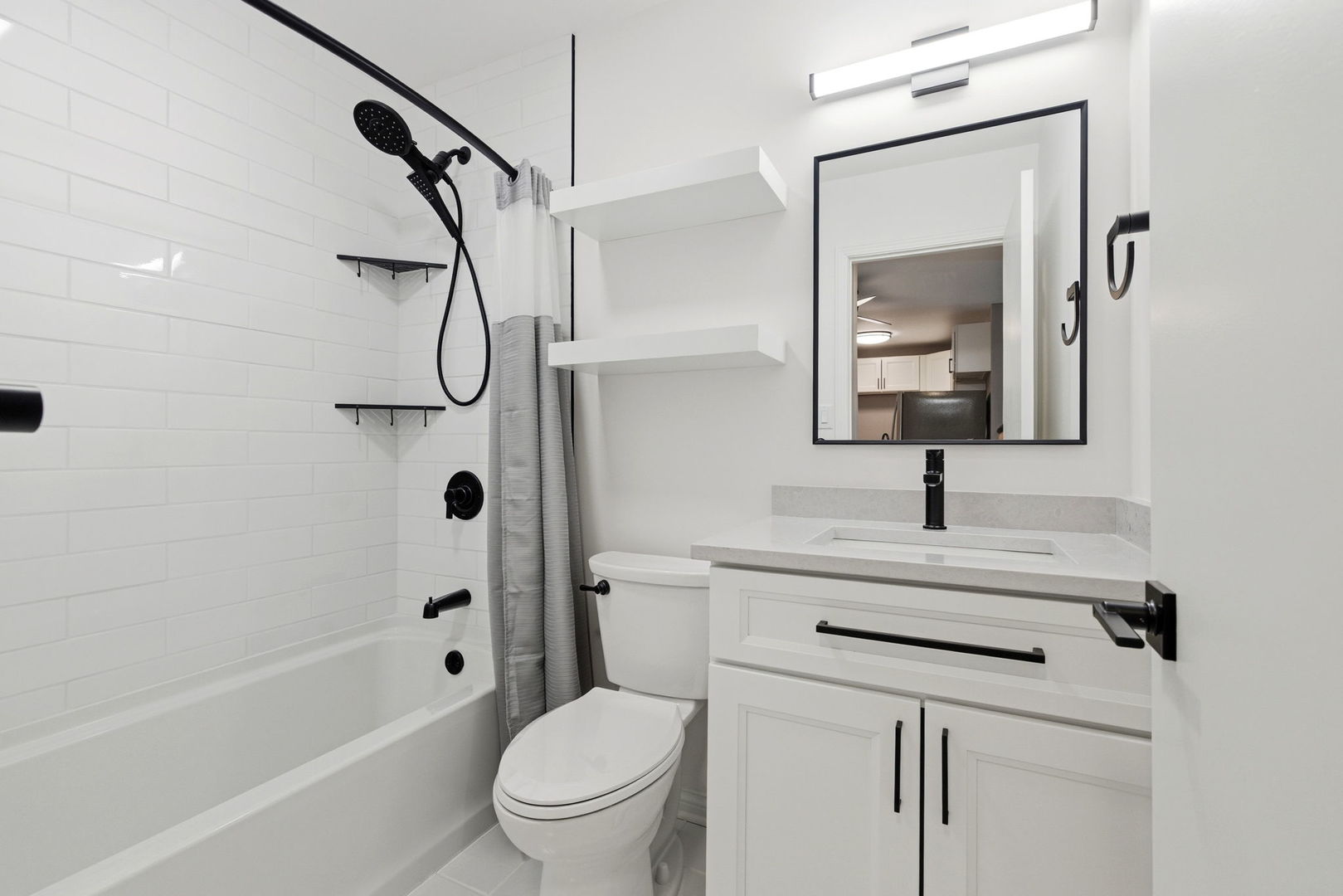 2800 Light Road, Unit 102 Oswego, IL 60543 - Photo 8 of 12 a bathroom with a sink a toilet and a mirror