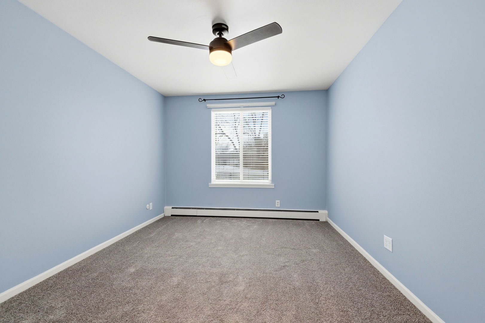 2800 Light Road, Unit 102 Oswego, IL 60543 - Photo 9 of 12 an empty room with ceiling fan and windows