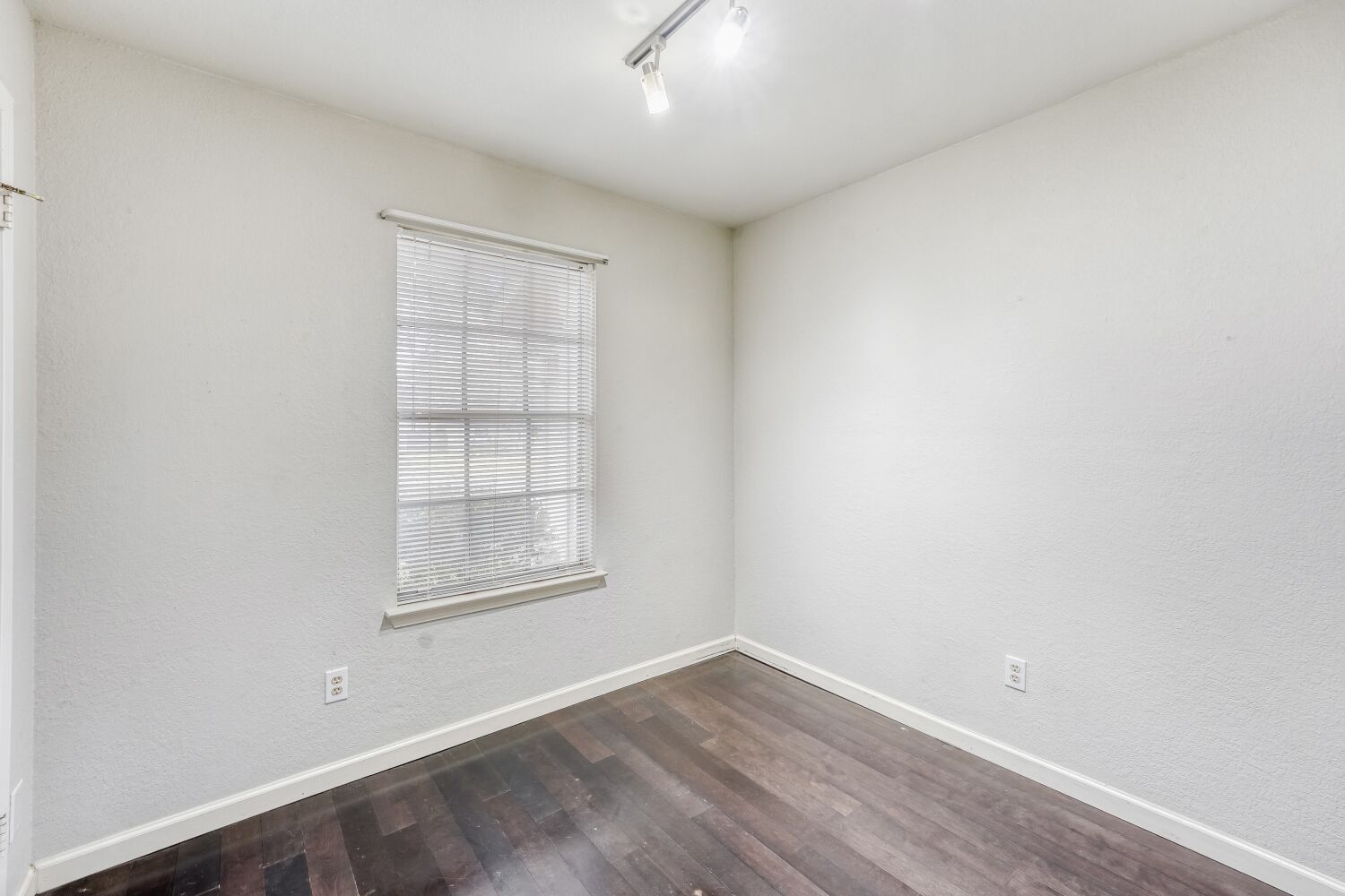 9100 Wagtail Drive Austin, TX 78748 - Photo 15 of 23 Bedroom featuring dark wood finished floors,, and rail lighting