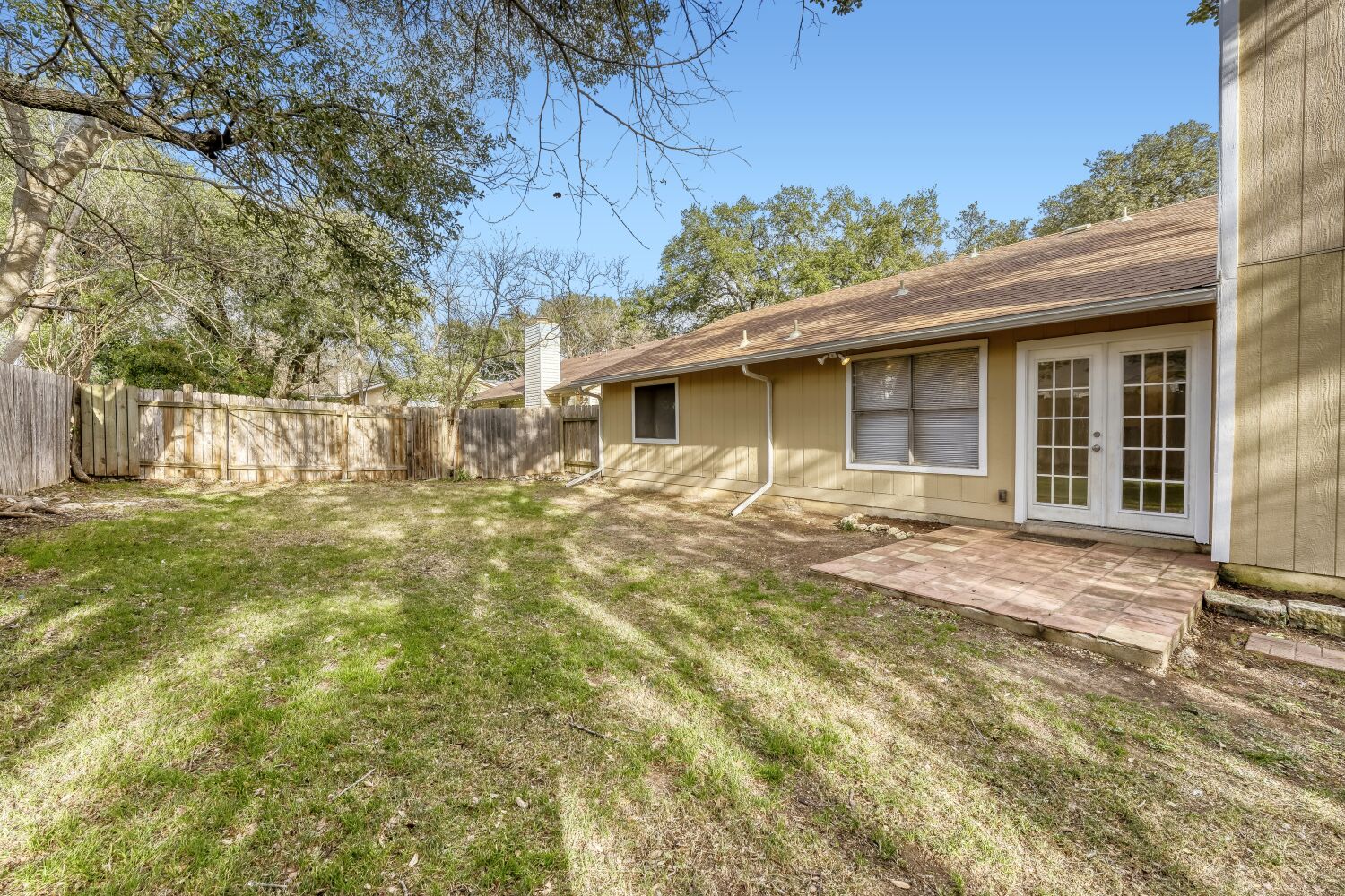 9100 Wagtail Drive Austin, TX 78748 - Photo 20 of 23 Fenced backyard with french doors and a patio area