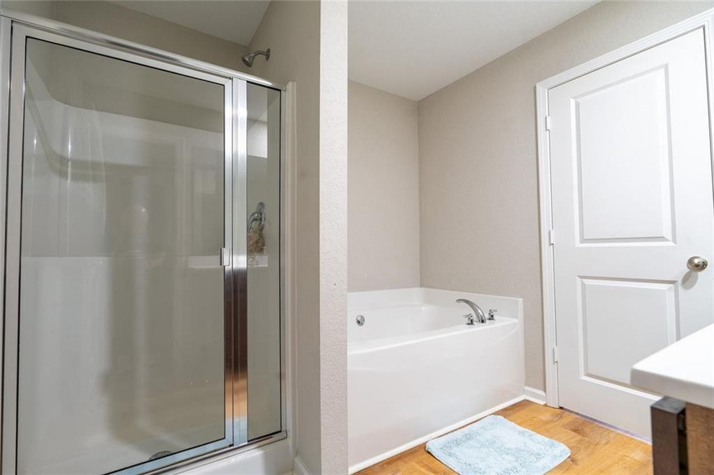 735 Walnut Creek Circle Pendergrass, GA 30567 - Photo 21 of 29 a bathroom with a tub and shower