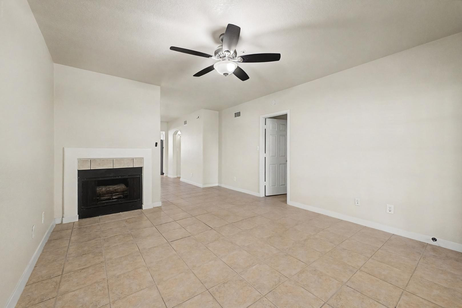 6885 East Cochise Road, Unit 142 Paradise Valley, AZ 85253 - Photo 16 of 47 a view of an empty room with chandelier fan and fire place