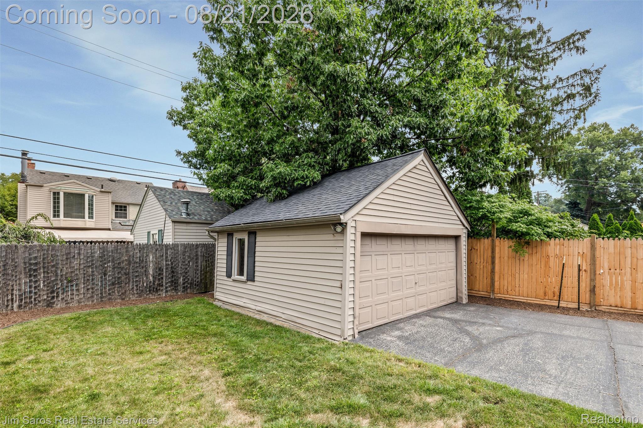 288 Moran Road Grosse Pointe, MI 48236 - Photo 22 of 24 Detached garage with horizontal siding and a panel-style garage door