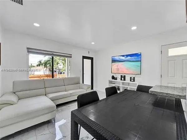 a view of a livingroom with furniture and a flat screen tv