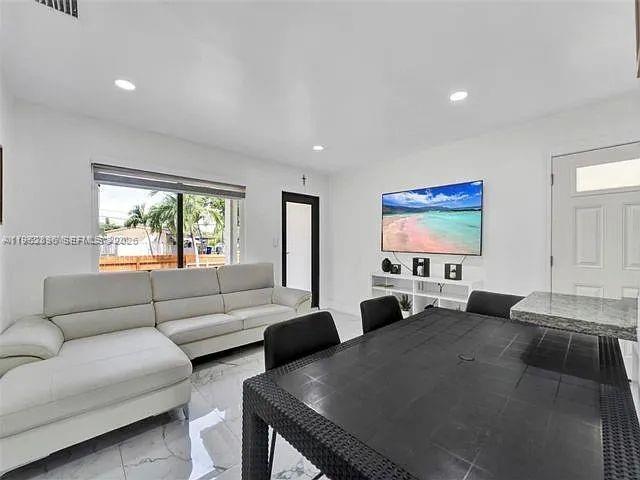 2730 Northeast 16th Avenue Pompano Beach, FL 33064 - Photo 11 of 16 a living room with furniture and a flat screen tv