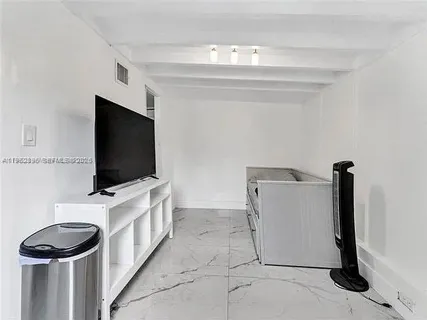 a kitchen with stainless steel appliances granite countertop a refrigerator and a stove