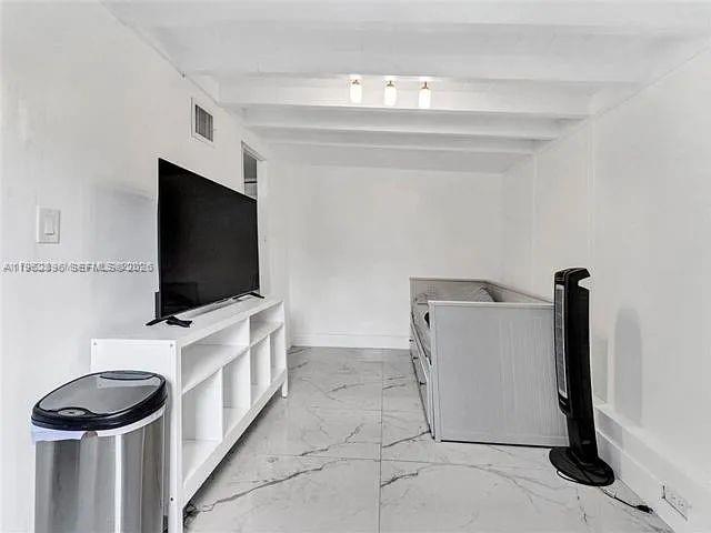2730 Northeast 16th Avenue Pompano Beach, FL 33064 - Photo 12 of 16 a view of a livingroom with furniture and a flat screen tv