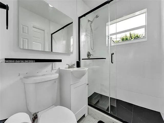 2730 Northeast 16th Avenue Pompano Beach, FL 33064 - Photo 15 of 16 a bathroom with a sink a toilet and a mirror