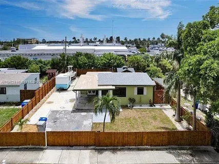 an aerial view of a house with a garden and a car park