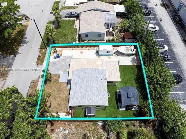 2730 Northeast 16th Avenue Pompano Beach, FL 33064 - Photo 3 of 16 an aerial view of a house with a garden and a car park