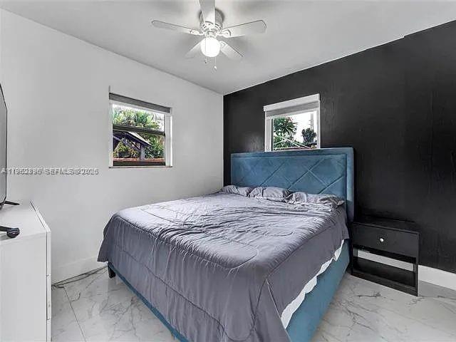 2730 Northeast 16th Avenue Pompano Beach, FL 33064 - Photo 7 of 16 a bedroom with a bed and a window
