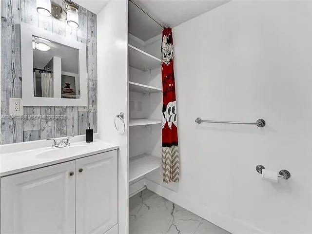 2730 Northeast 16th Avenue Pompano Beach, FL 33064 - Photo 8 of 16 a bathroom with a sink vanity and a shower