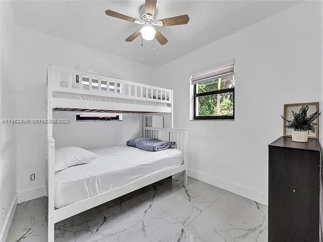 2730 Northeast 16th Avenue Pompano Beach, FL 33064 - Photo 10 of 16 a bedroom with a bed and a chandelier