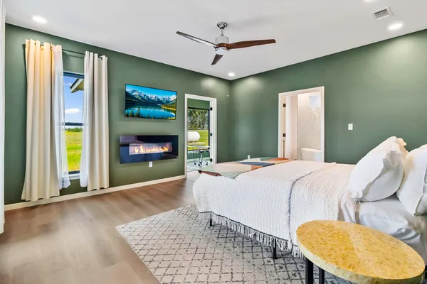 a bedroom with a bed and a fireplace