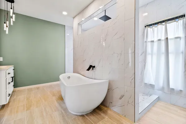 a bathroom with a bathtub and shower