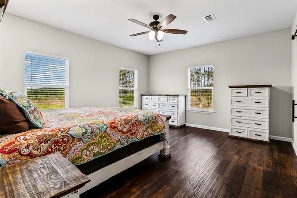 a bedroom with a bed and a chandelier