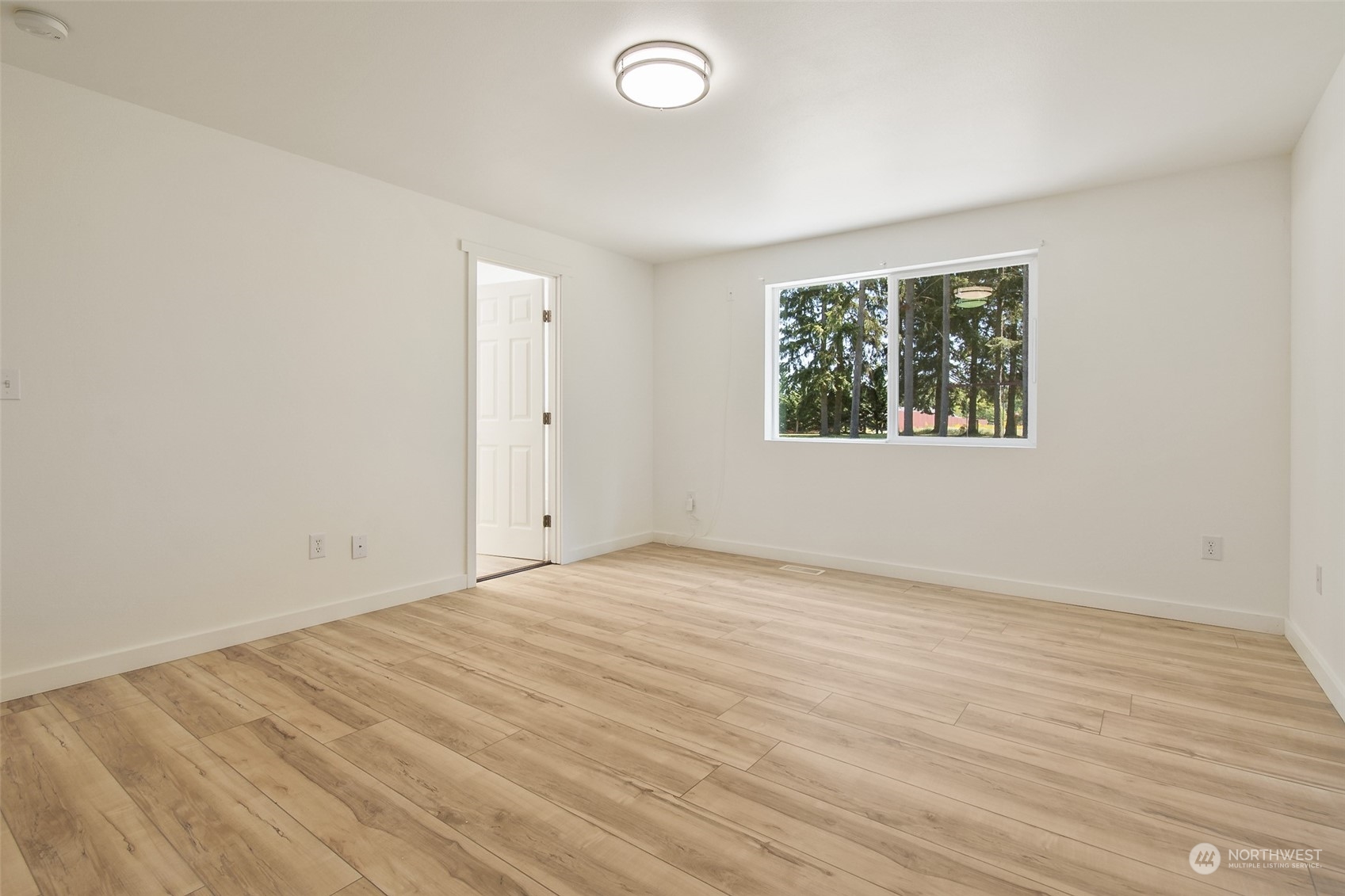 18032 Mary Lane Southwest Rochester, WA 98579 - Photo 12 of 29 an empty room with wooden floor and windows