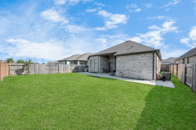 a view of a house with a yard and sitting area