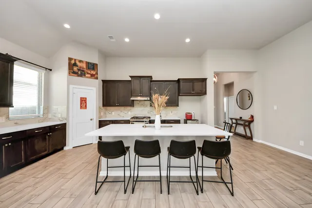 a large kitchen with a table and chairs in it
