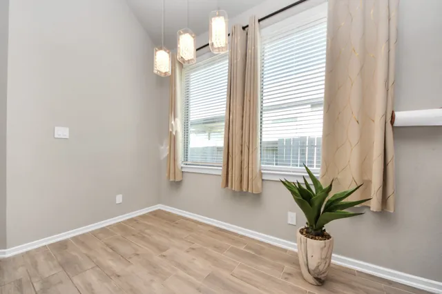 a view of an entryway with wooden floor and a livingroom top