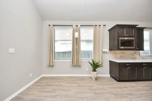 a large white kitchen with a large window