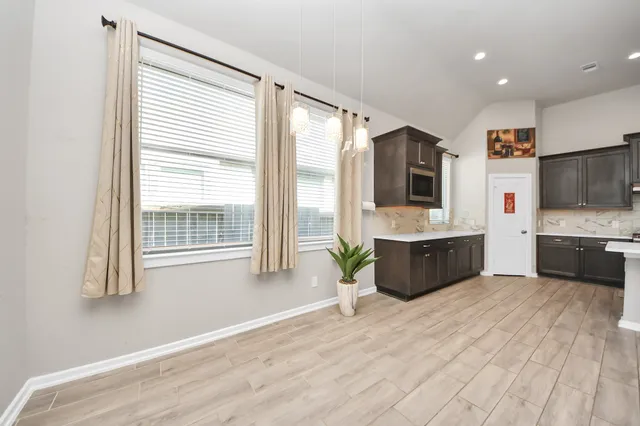 a view of a kitchen with furniture and a ceiling fan