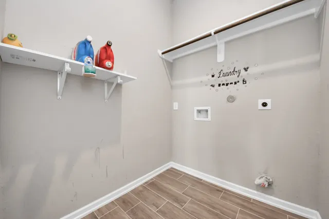 an empty room with a window and wooden floor