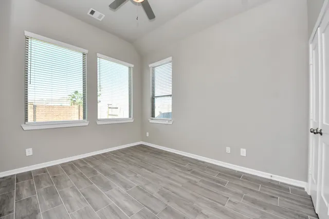 wooden floor in an empty room with a window