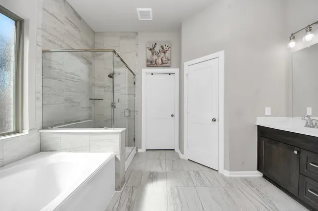 a spacious bathroom with a double vanity sink and a mirror